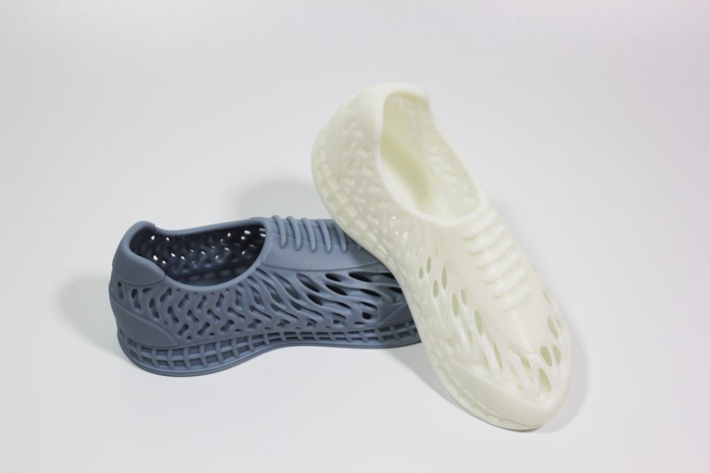 SLA resin 3D printed shoe models in grey and white, highlighting customizable color options available for our professional printing service