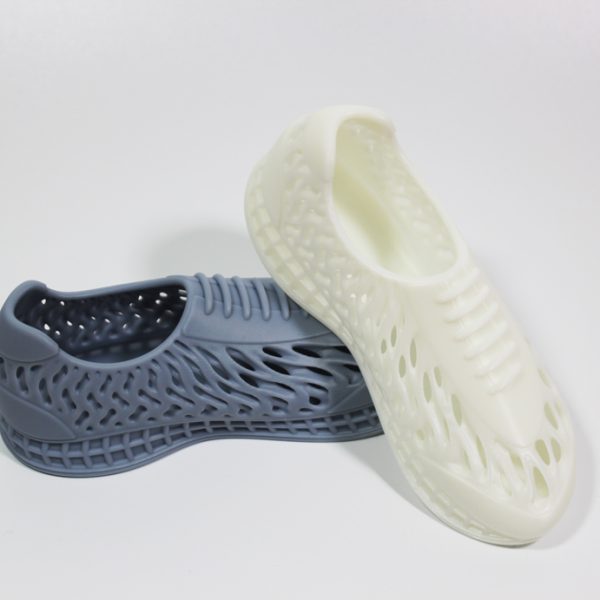 SLA resin 3D printed shoe models in grey and white, highlighting customizable color options available for our professional printing service